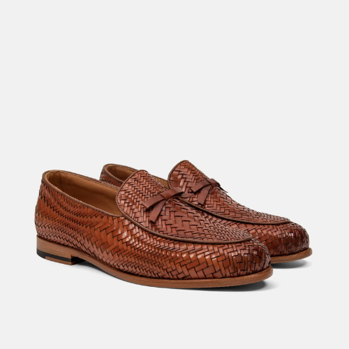 pair of brown loafers against white background