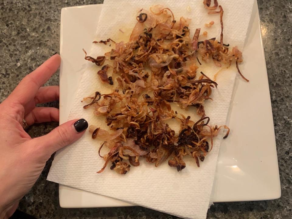 crispy caramelized red onions on a paper towel