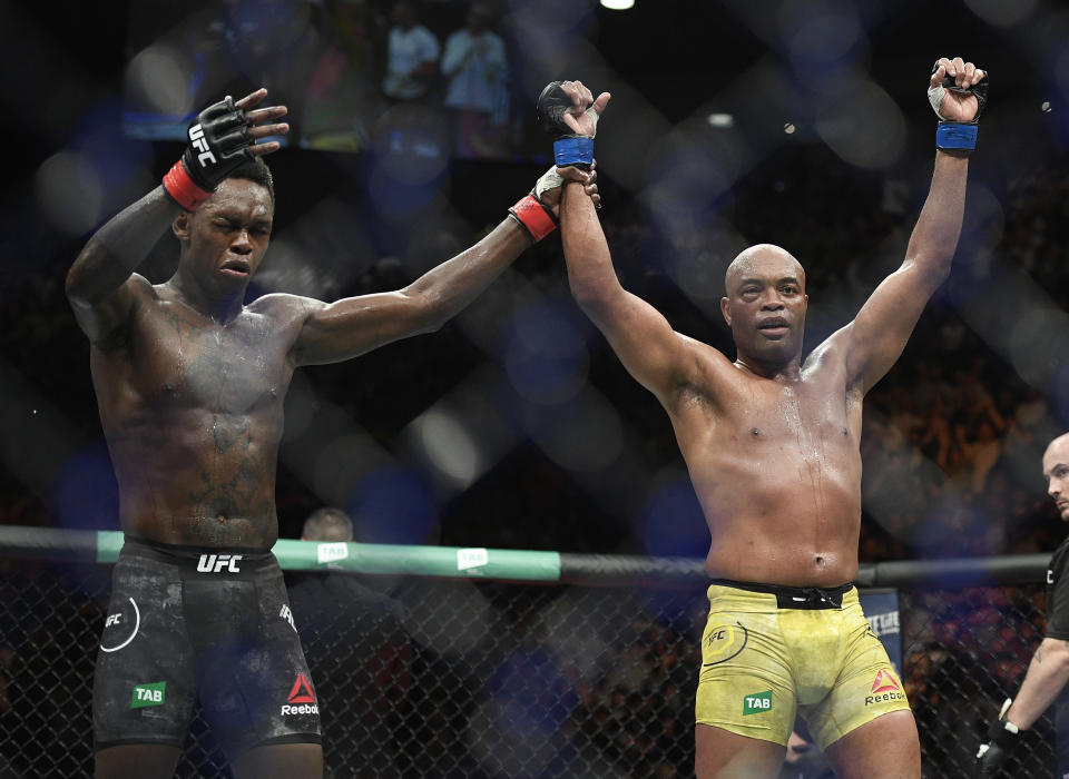 Nigeria's Israel Adesanya, left, reacts after defeating Brazil's Anderson Silva during their middleweight bout at the UFC 234 event in Melbourne, Australia, Sunday, Feb. 10, 2019. (AP Photo/Andy Brownbill)