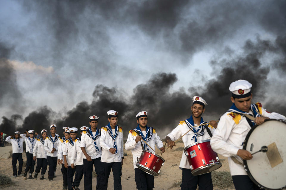 <p>Palestinian boy scouts march during a protest on the beach near the border with Israel in Beit Lahiya, northern Gaza Strip, Monday, Sept. 10, 2018. Thousands of Palestinians gathered on the beach Monday in a Hamas-led protest to demand end of an 11-year Israeli-Egyptian blockade. (AP Photo/Felipe Dana) </p>