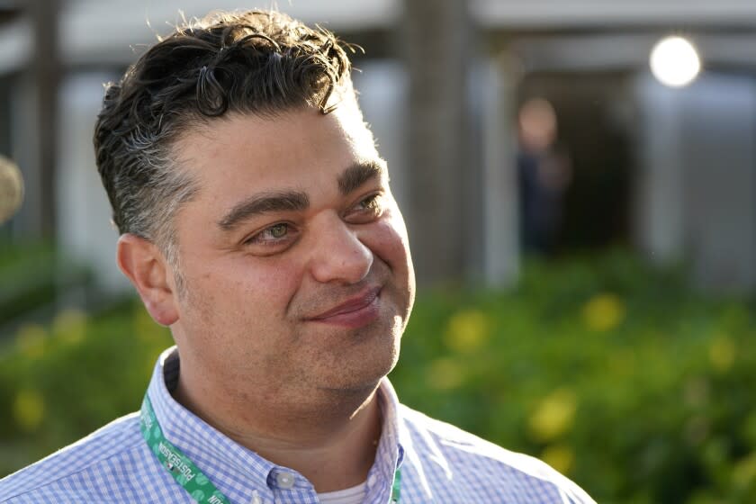 Los Angeles Angels general manager Perry Minasian talks with reporters during Major League Baseball's general managers meetings Tuesday, Nov. 9, 2021, in Carlsbad, Calif. (AP Photo/Gregory Bull)