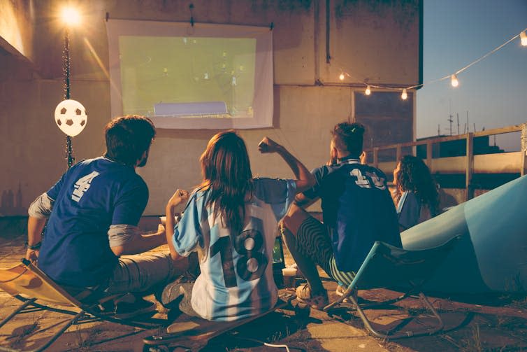 Friends watching a football game together