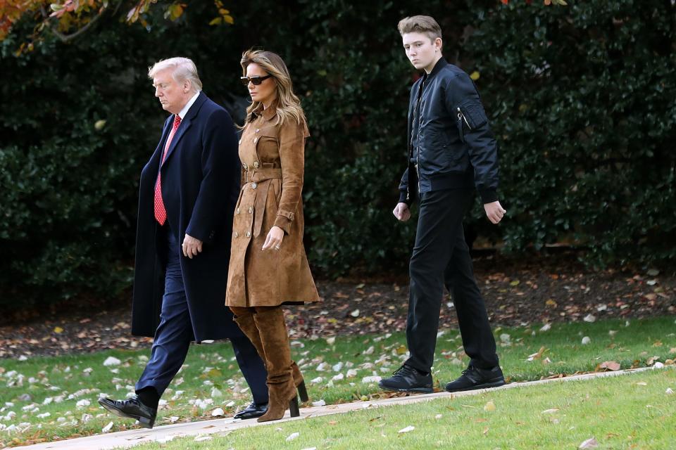 President Donald Trump, first lady Melania Trump and Barron Trump, 13, who towers over his parents, walk across the South Lawn to Marine One on  Nov. 26, 2019, on their way to Florida for Thanksgiving.