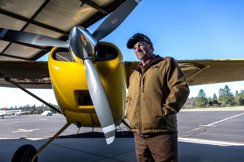 Pilot Scott Herring stands next to one of his airplanes at the Georgetown Airport on Friday. He has several businesses at the airport, including Airfilm Camera Systems, which makes of aircraft mounts for imaging systems. Herring and other pilots say that tree growth near the runway has made for dangerous conditions. Hector Amezcua/hamezcua@sacbee.com