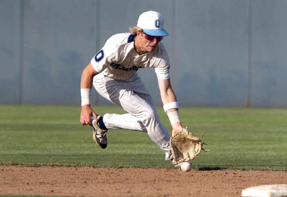 Oakmont shortstop KC Tibbits scoops up a ground ball during the Sac-Joaquin Section DIII championship game with Central Catholic at Islanders Park in Lathrop, Calif., Thursday, May 23, 2024.