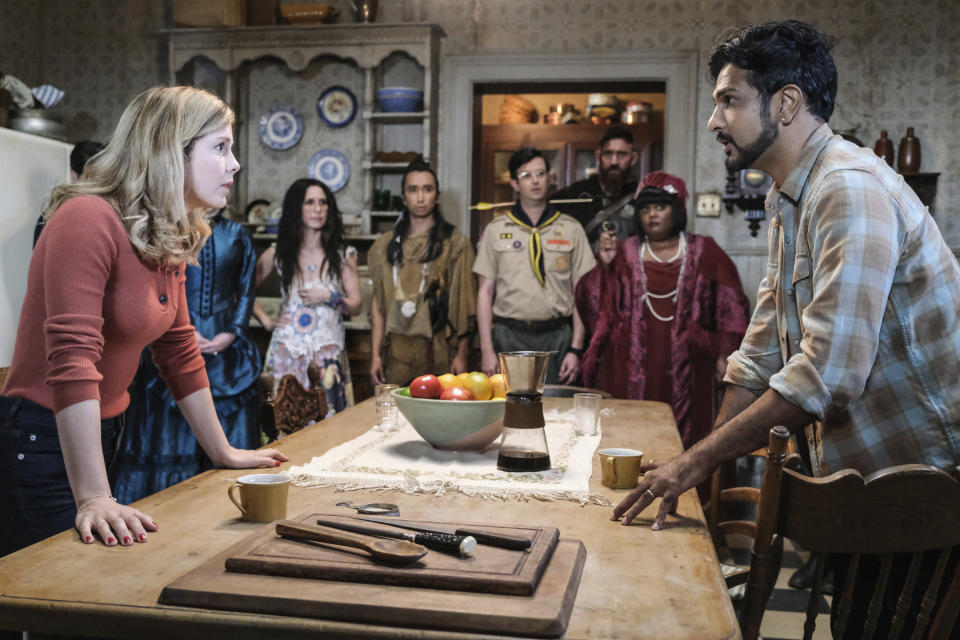 This image released by CBS shows Rose McIver, foreground left, and Utkarsh Ambudkar in a scene from the comedy series "Ghosts." (Bertrand Calmeau/CBS via AP)