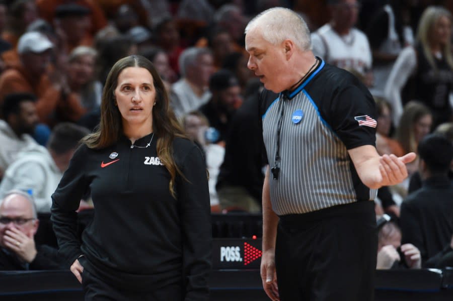 Gonzaga coach Lisa Fortier, left, talks with a referee during the first half of the team’s Sweet 16 college basketball game against Texas in the women’s NCAA Tournament, Friday, March 29, 2024, in Portland, Ore. (AP Photo/Steve Dykes)