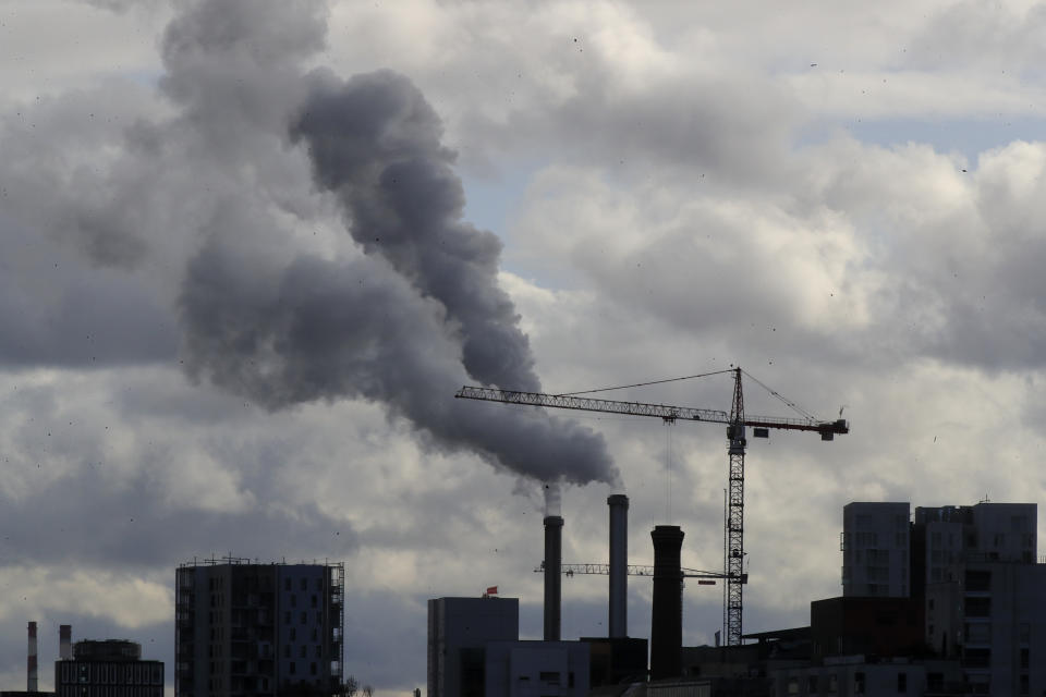 Smoke billows from a plant just outside the French capital, Wednesday, Nov. 13, 2019 in Paris. The world's thirst for oil will continue to grow until the 2030s, with climate-damaging emissions climbing until at least 2040 — and consumers' insatiable appetite for SUVs is a big reason why. (AP Photo/Michel Euler)