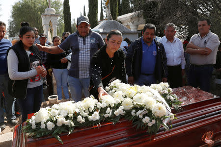 Alicia Moreno (C), wife of late Cesar Jimenez Brito, 40, who died during the explosion of a fuel pipeline ruptured by suspected oil thieves, gestures during his funeral service at the cemetery in the municipality of Tlahuelilpan, state of Hidalgo, Mexico January 20, 2019. REUTERS/Henry Romero