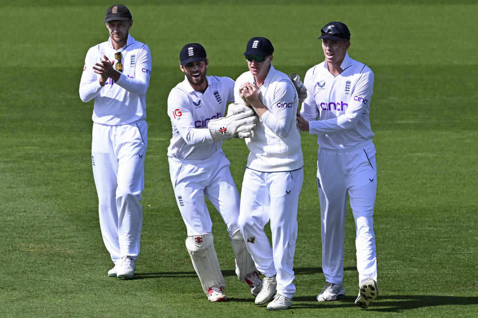 England's Harry Brook, second right, takes a catch to dismiss New Zealand's Henry Nicholls as England teammates Joe Root, left, Ben Foakes, second left, and Zak Crawley, right, congratulate him on day 4 of their cricket test match in Wellington, New Zealand, Monday, Feb 27, 2023. (Andrew Cornaga/Photosport via AP)