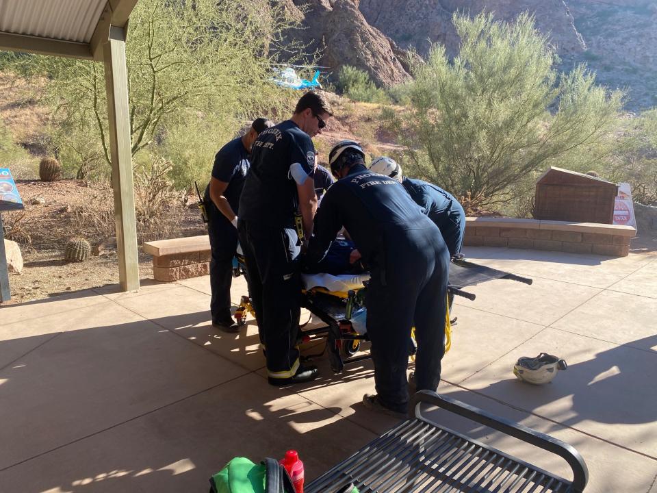 Phoenix firefighters assist an injured hiker at Camelback Mountain on Nov. 12, 2021.