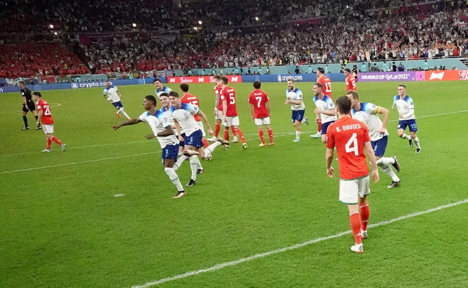 DOHA, QATAR - NOVEMBER 29: (EDITORS NOTE: In this photo taken from a remote camera from inside the goal) England's Marcus Rashford celebrates scoring their first goal during the FIFA World Cup Qatar 2022 Group B match between Wales and England at Ahmad Bin Ali Stadium on November 29, 2022 in Doha, Qatar. (Photo by Hannah McKay - Pool/Getty Images)