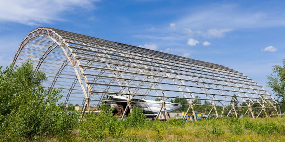 An hangar at Hostomel airport, with part of a ruined plane - possibly the Mriya-225 - visible inside, on August 10, 2023