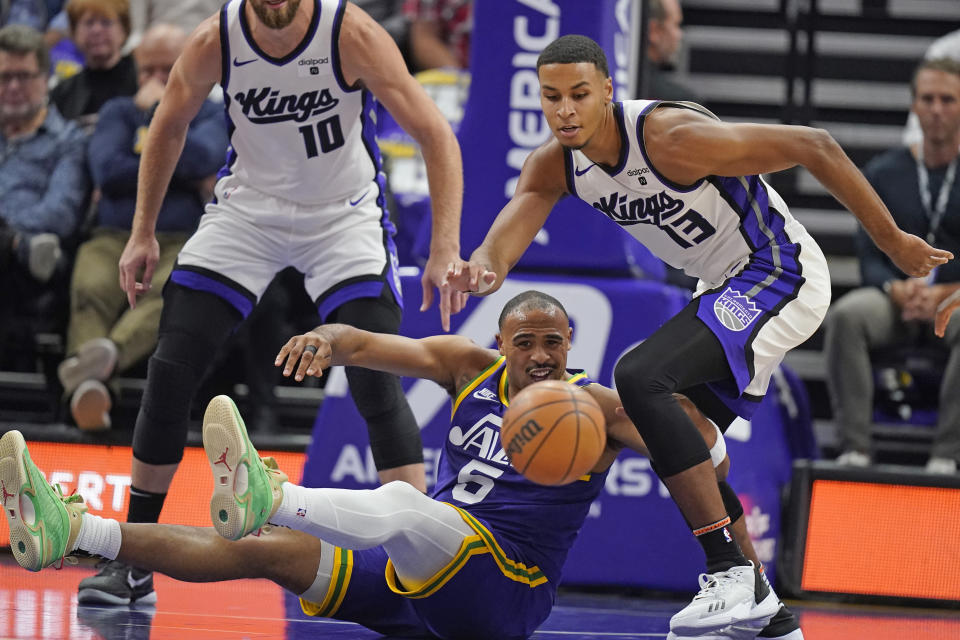 Utah Jazz guard Talen Horton-Tucker (5) loses the ball as Sacramento Kings forward Keegan Murray (13) looks for it during the first half of an NBA basketball game Wednesday, Oct. 25, 2023, in Salt Lake City. (AP Photo/Rick Bowmer)