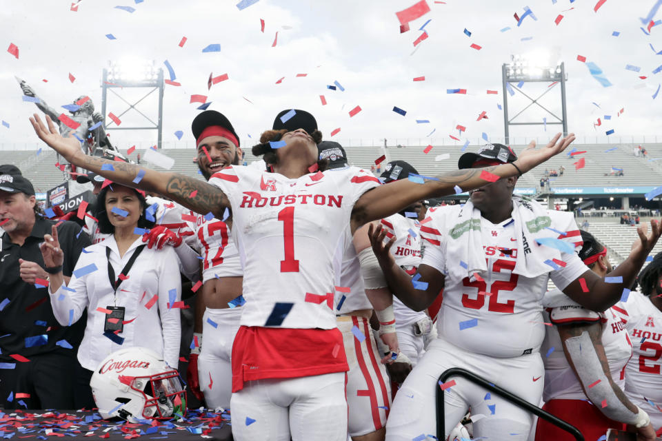 Houston wide receiver Nathaniel Dell (1) celebrates with teammates after the defeated Auburn in the Birmingham Bowl NCAA college football game Tuesday, Dec. 28, 2021, in Birmingham, Ala. (AP Photo/Butch Dill)