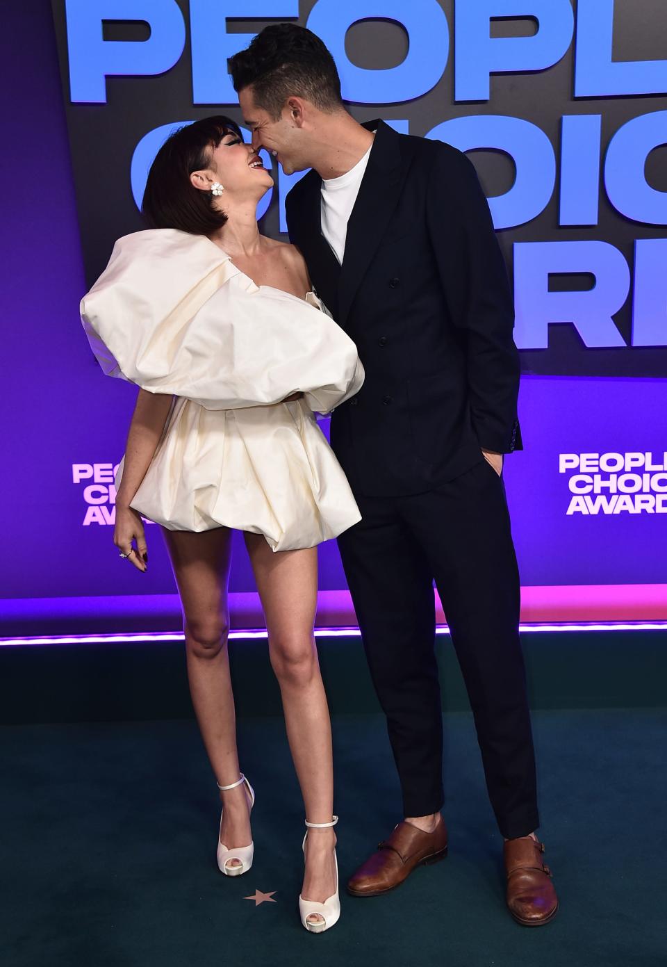 Sarah Hyland, left, and Wells Adams kiss as they arrive at the People's Choice Awards on Dec. 7, 2021. The couple got married during a ceremony Saturday, two years after postponing their original nuptials.