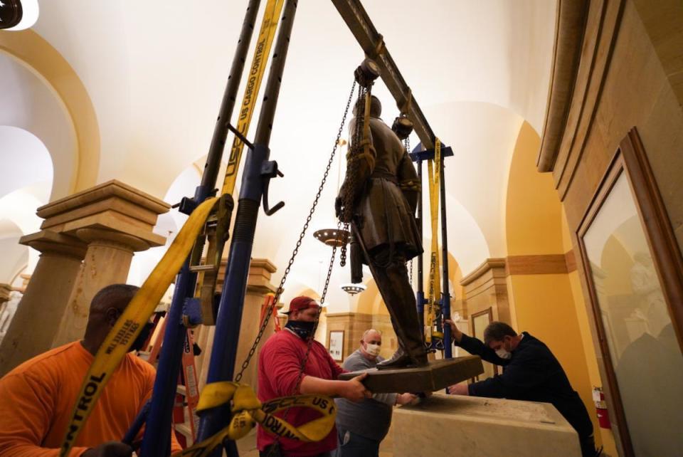 FILE - In this Dec. 21, 2020, file photo provided by the Office of the Governor of Virginia shows workers removing a statue of Confederate Gen. Robert E. Lee from the National Statuary Hall Collection in Washington. The statue that represented Virginia in the U.S. Capitol for 111 years was removed after a state commission decided that Lee was not a fitting symbol for the state. (Jack Mayer/Office of Governor of Virginia, File)