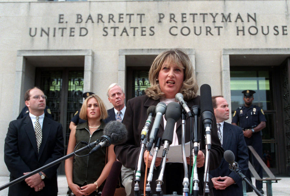 FILE - In this July 29, 1998, file photo Linda Tripp meets with reporters outside federal court in Washington after her final appearance before a grand jury investigating an alleged affair between President Bill Clinton and Monica Lewinsky. Tripp, whose secretly recorded conversations with White House intern Lewinsky led to the 1998 impeachment of Clinton, died Wednesday, April 8, 2020, at age 70. (AP Photo/Khue Bui, File)