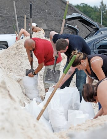 Local residents fill sandbags ahead of the arrival of Hurricane Dorian in Kissimmee