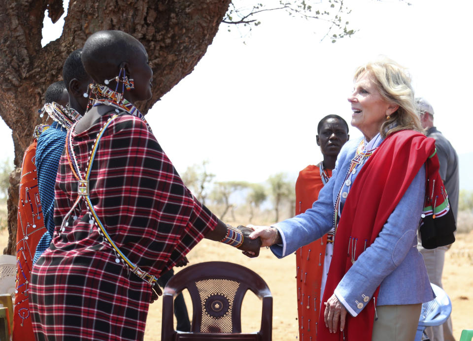 US first Lady Jill Biden, right, shakes hands with women of the Maasai community during her visit to Ngatataek, Kajiado Central, Kenya, Sunday, Feb. 26, 2023. Biden traveled on Sunday to an area near Kenya's border with Tanzania to raise awareness about a severe drought that is endangering lives and livelihoods.(AP Photo/Brian Inganga)