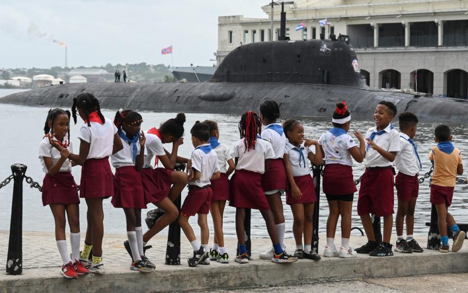 Schoolchildren take pictures of nuclear-powered submarine Kazan, part of the Russian naval detachment visiting Cuba (AFP via Getty Images)