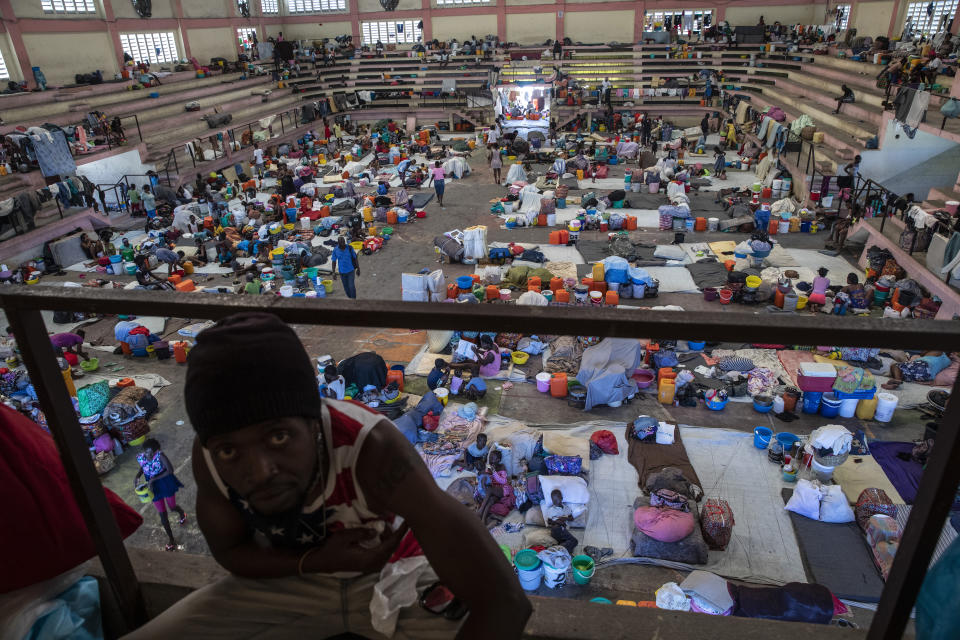 Internally displaced people due to gang violence shelter in the Center Sportif of Carrefour, in Port-au-Prince, Haiti, Saturday, Sept. 18, 2021. Families with young children have been sleeping on concrete floors of the gymnasium since mid-June, with only a sheet serving as a bed and their scant belongings stuffed into bags nearby. (AP Photo/Rodrigo Abd)