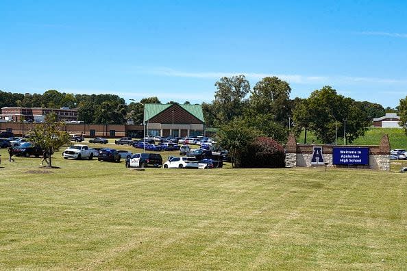 WINDER, GEORGIA - SEPTEMBER 4: Cars are parked on the lawn of the school after a shooting at Apalachee High School on September 4, 2024 in Winder, Georgia. Four fatalities and multiple injuries have been reported, and a 14-year-old suspect is in custody according to authorities. (Photo by Megan Varner/Getty Images)