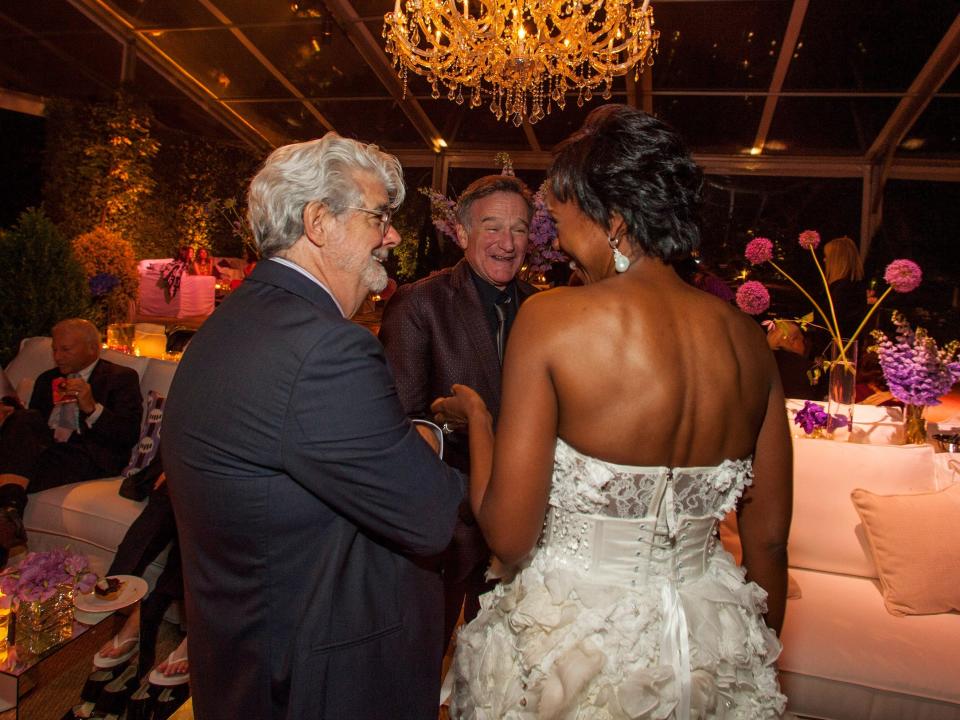 George Lucas and Mellody Hobson talk with Robin Williams during wedding reception