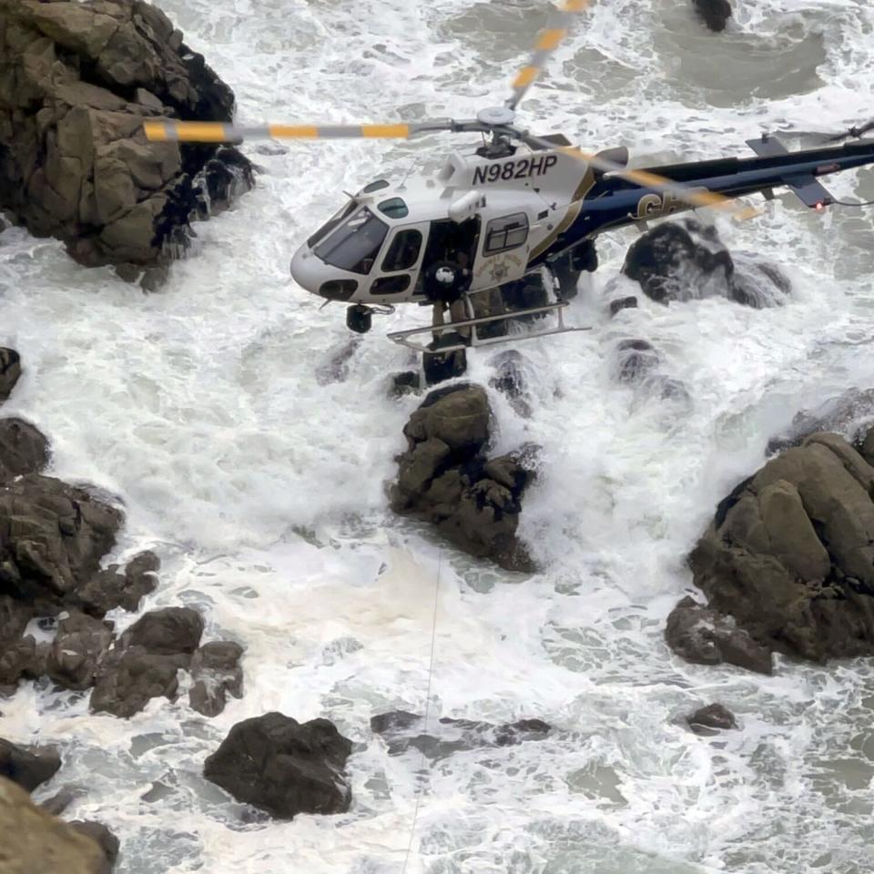 A helicopter joins rescue efforts in Northern California on Monday.