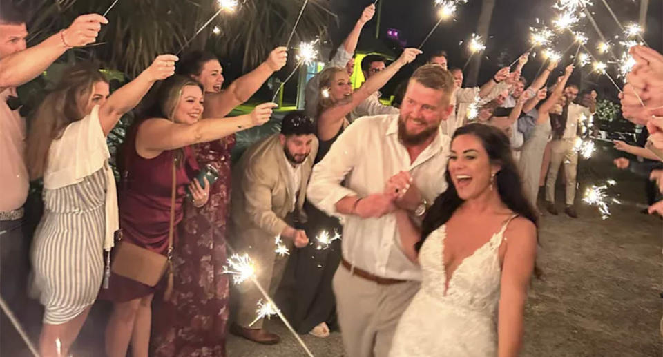 Aric Hutchinson and Samantha Hutchinson walk through an arc of sparklers as they leave their wedding reception, moments before Sam was killed by a drunk driver.