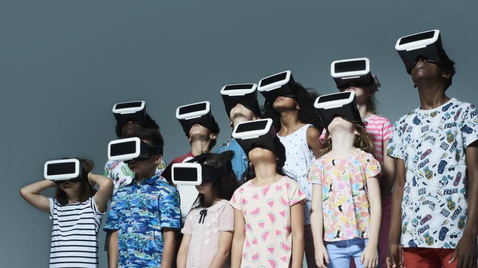 Kids and teenagers wearing VR headsets