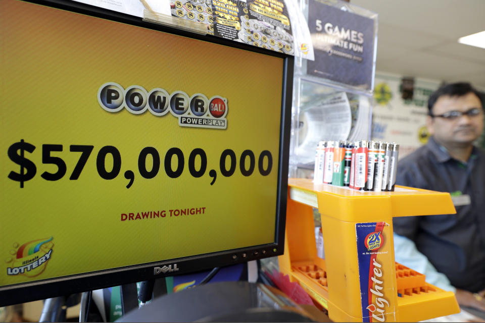 FILE - In this Jan. 6, 2018 file photo, a Powerball lottery sign displays the lottery prizes at a convenience store in Chicago. Lottery jackpots are going to shrink as the coronavirus pandemic tamps down lottery sales. The group that oversees the Powerball game announced Wednesday, March 25, 2020, that it would cut minimum jackpots in half, from $40 million to $20 million, after there is a winner of the current big prize. The jackpot also could grow more slowly, with minimum increases of $2 million instead of the normal $10 million after each twice-weekly drawing. (AP Photo/Nam Y. Huh File)