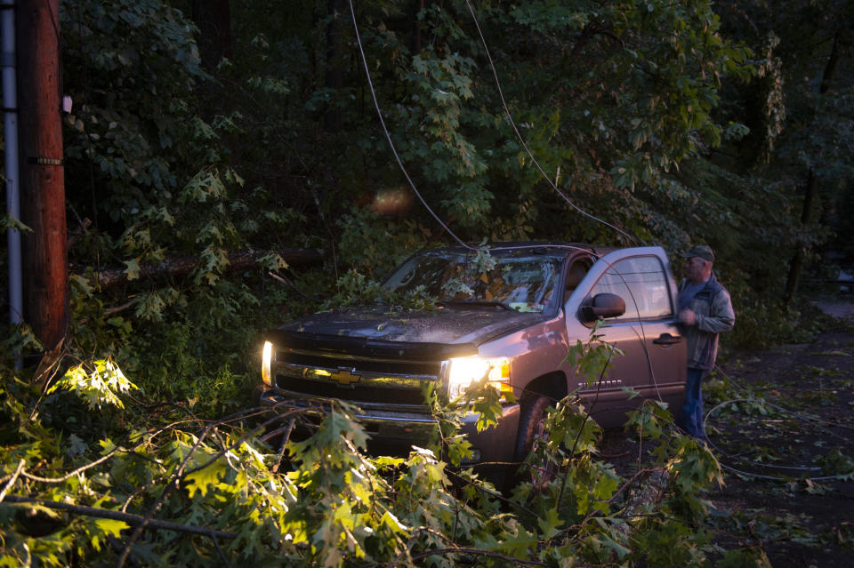 Jim Mattis gets something out of his truck after a suspected tornado tore through Charleston, W.Va., Monday, June 24, 2019. (Craig Hudson/Charleston Gazette-Mail via AP)