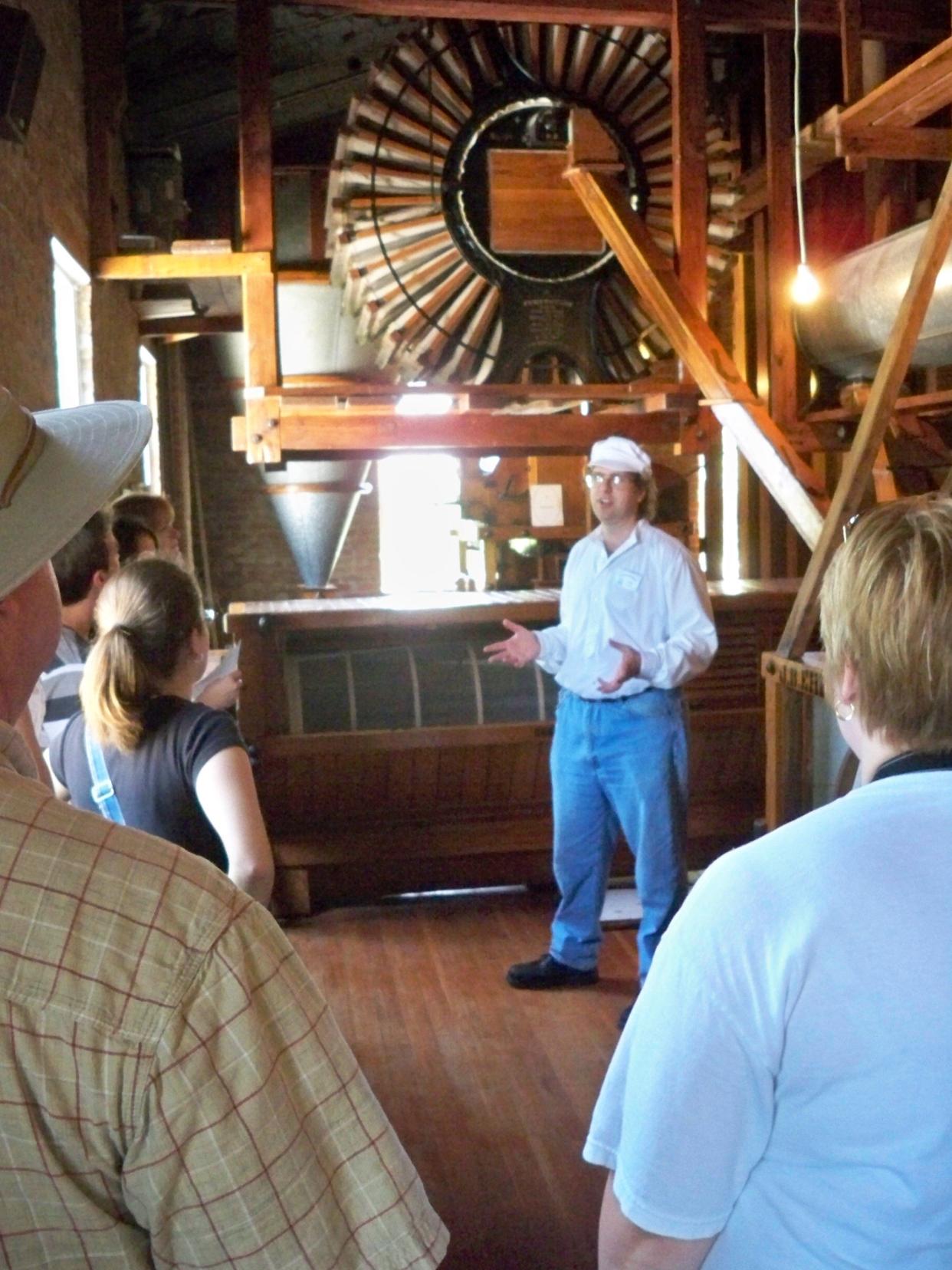 A miller speaks about the workings of the Old Mill in Lindsborg. The historic flour mill at the Lindsborg Old Mill and Swedish Heritage Museum will be running Saturday as part of the museum's Millfest events.