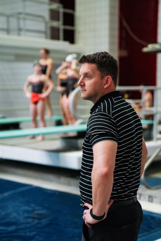 Georgia diving coach Chris Colwill stands poolside.