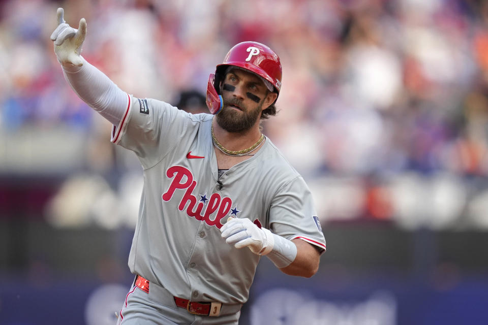 Philadelphia Phillies' Bryce Harper (3) celebrates as he rounds the bases after hitting a home run against the New York Mets during the fourth inning of a London Series baseball game in London, Saturday, June 8, 2024. (AP Photo/Kirsty Wigglesworth)