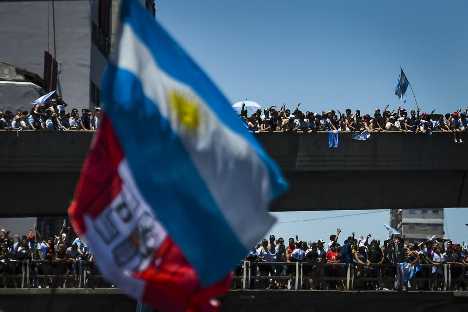 BUENOS AIRES, ARGENTINA - DECEMBER 20: Fans of Argentina celebrate from the 25 de Mayo highway as they gather for the victory parade of the Argentina men's national football team after winning the FIFA World Cup Qatar 2022 on December 20, 2022 in Buenos Aires, Argentina. (Photo by Marcelo Endelli/Getty Images)