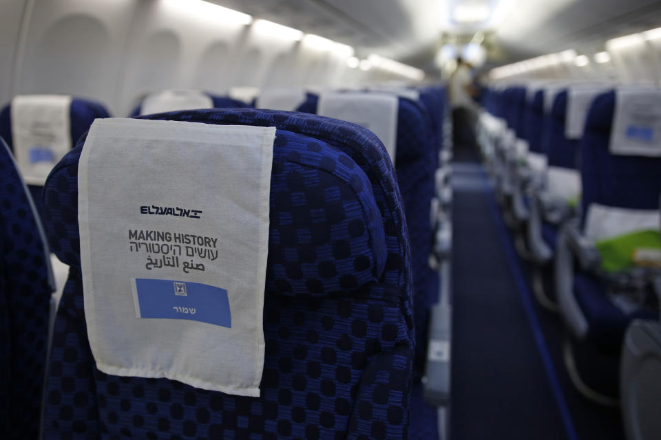 A seat covering reading in Arabic, English and Hebrew "making history" is in the Israeli flag carrier El Al's airliner which will carry Israeli and U.S. delegations to Abu Dhabi for talks meant to put final touches on the normalization deal between the United Arab Emirates and Israel, at Ben Grunion International Airport, near Tel Aviv, Israel Monday, Aug. 31, 2020. (Nir Elias/Pool Photo via AP)
