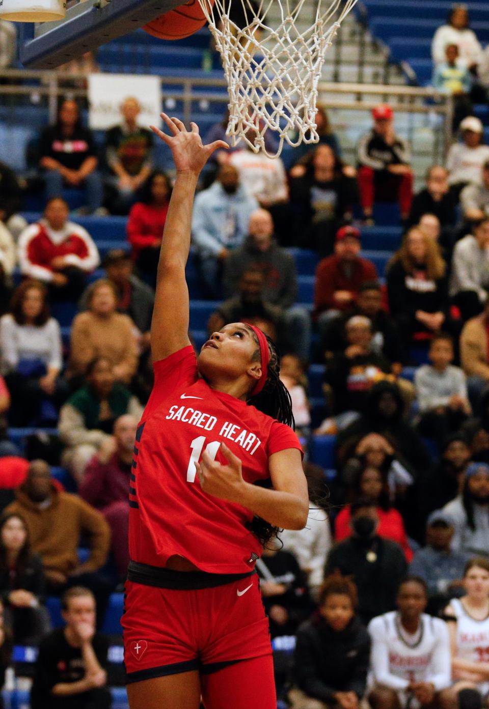 Sacred Heart’s ZaKiyah Johnson makes a basket against Manual on Saturday. Johnson scored a team-high 21 points.