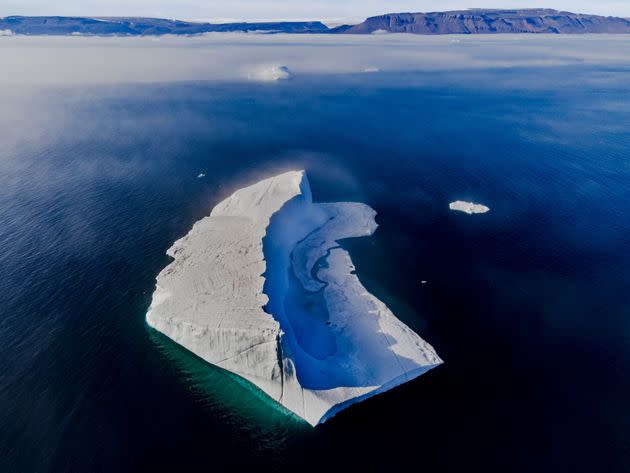 A melting pond is seen inside an iceberg from the Greenland ice sheet in the Baffin Bay near Pituffik, Greenland, on July 17, 2022.