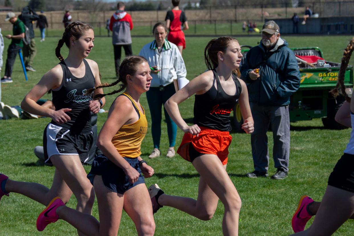 Hillsdale junior Chloe Stalhood (left, pictured here battling Keria Knight of Jonesville) set a new personal best time in the 3200 to grow her lead in the rankings by more than 30 seconds.