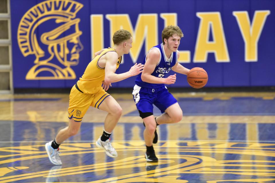 Croswell-Lexington's Zachary Kroetsch dribbles the ball during the Pioneers' 64-51 win over Imlay City at Imlay City High School on Friday.