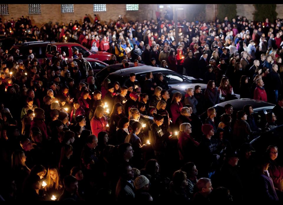 Students and those in the community embrace one another as they hold a candlelight vigil at St Mary's of the Assumption Church in Chardon, Ohio on Feb. 28, 2012. 