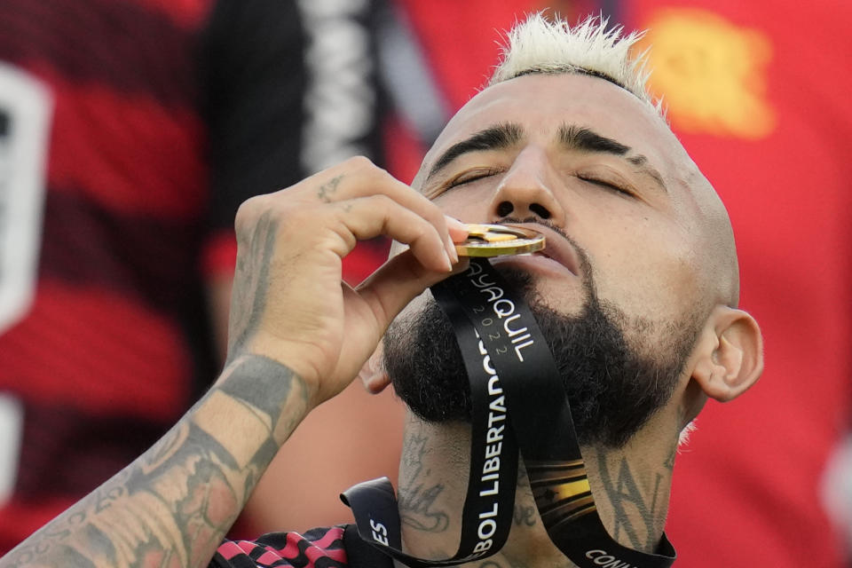 Arturo Vidal of Brazil's Flamengo kisses his medal after winning the Copa Libertadores final soccer match against Brazil's Athletico Paranaense at the Monumental Stadium in Guayaquil, Ecuador, Saturday, Oct. 29, 2022. (AP Photo/Fernando Vergara)