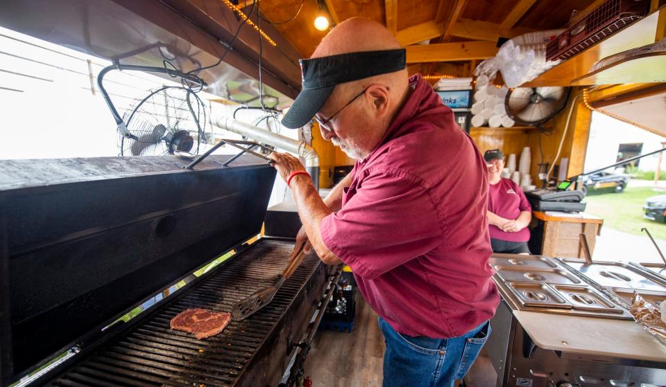 JD Faulk makes a ribeye for a sandwich at JD's Ribeye at the Monroe County Fair at the Monroe County Fairgrounds on Monday, July 3, 2023.