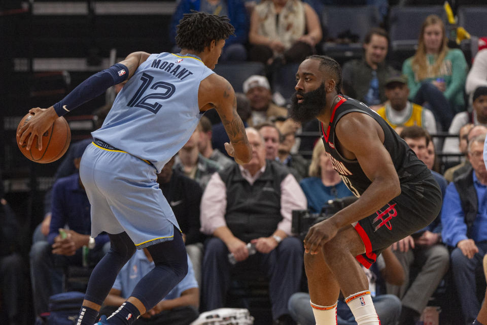 Jan 14, 2020; Memphis, Tennessee, USA; Memphis Grizzlies guard Ja Morant (12) handles the ball against Houston Rockets guard James Harden (13) during the first half at FedExForum. Mandatory Credit: Justin Ford-USA TODAY Sports