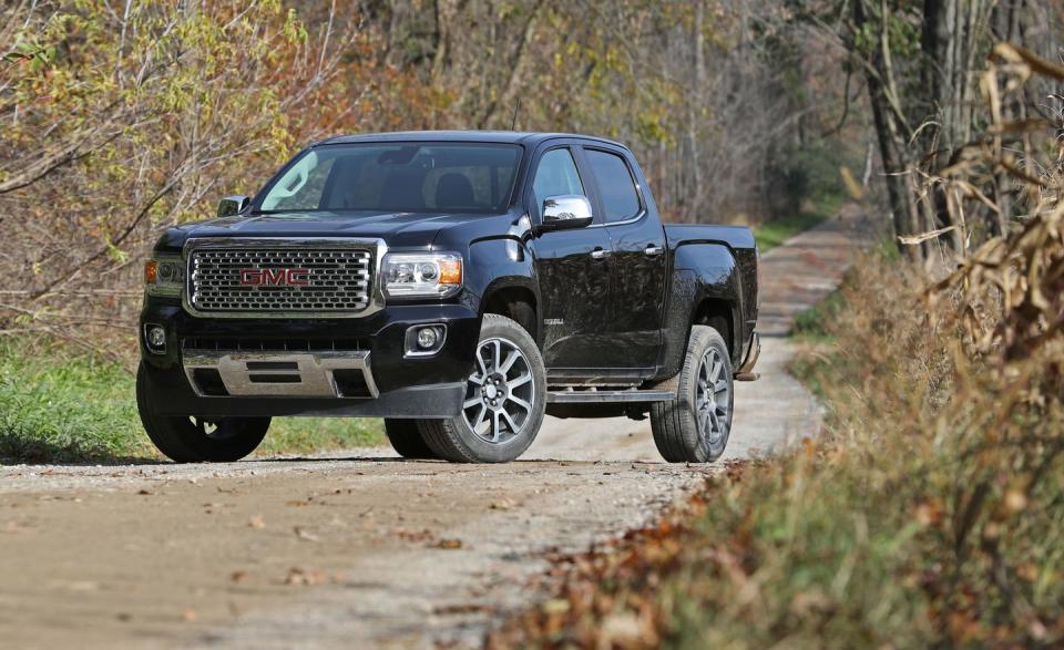 <p><a rel="nofollow noopener" href="https://www.caranddriver.com/gmc/canyon" target="_blank" data-ylk="slk:The mid-size GMC Canyon;elm:context_link;itc:0;sec:content-canvas" class="link ">The mid-size GMC Canyon</a> doesn't stray too far from the blueprint of the full-size GMC Sierra pickup. So, if you like GMC's bigger truck but wish it were available in 7/10ths scale, the Canyon is your ride. But it's also the nearly-identical Chevrolet Colorado's kissing cousin, and in most cases the GMC Canyon doesn't offer enough unique content to warrant shelling out the extra cash GMC charges for its badging. (The two GM trucks share gas four- and six-cylinder engines, as well as a diesel four-cylinder.) The exception, of course, is the full-boat Denali trim, which is the perfect mount for curbside cowboys and cowgirls with an itch for mid-size bling.</p>