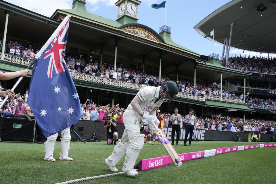 Australia's David Warner takes to the field to bat in his final test before retiring, on the fourth day of their cricket test match against Pakistan in Sydney, Saturday, Jan. 6, 2024. (AP Photo/Rick Rycroft)