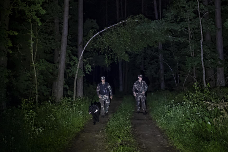 FILE - In this file photo taken on Thursday, June 10, 2021, Members of the Lithuania State Border Guard Service patrol on the border with Belarus, near the small town Kapciamiestis, some 160km (100 miles) of the capital Vilnius, Lithuania. Lithuanian authorities said Friday that the Baltic country has stemmed the flow of third country migrants illegally crossing from neighboring Belarus, saying the influx of people knocking at the external border of European Union seems to have halted and hundreds have been turned away. (AP Photo/Mindaugas Kulbis, File)