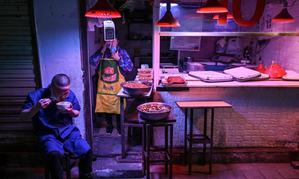 A man eats in a market in Wuhan